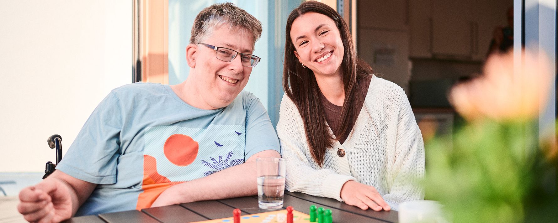 Zwei Menschen spielen "Mensch ärgere dich nicht"